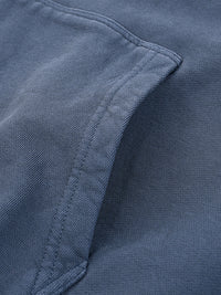 Close-up of a blue heavyweight streetwear garment pocket with textured fabric
