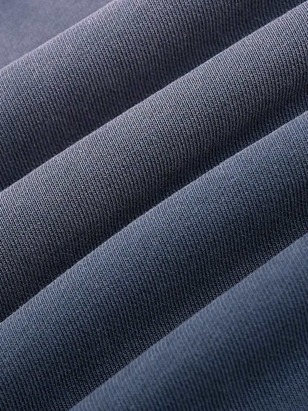 Close-up of heavyweight dark gray knit fabric with textured ribbed details