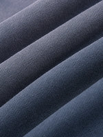Close-up of heavyweight dark gray knit fabric with textured ribbed details