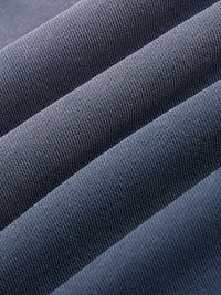 Close-up of heavyweight dark gray knit fabric with textured ribbed details