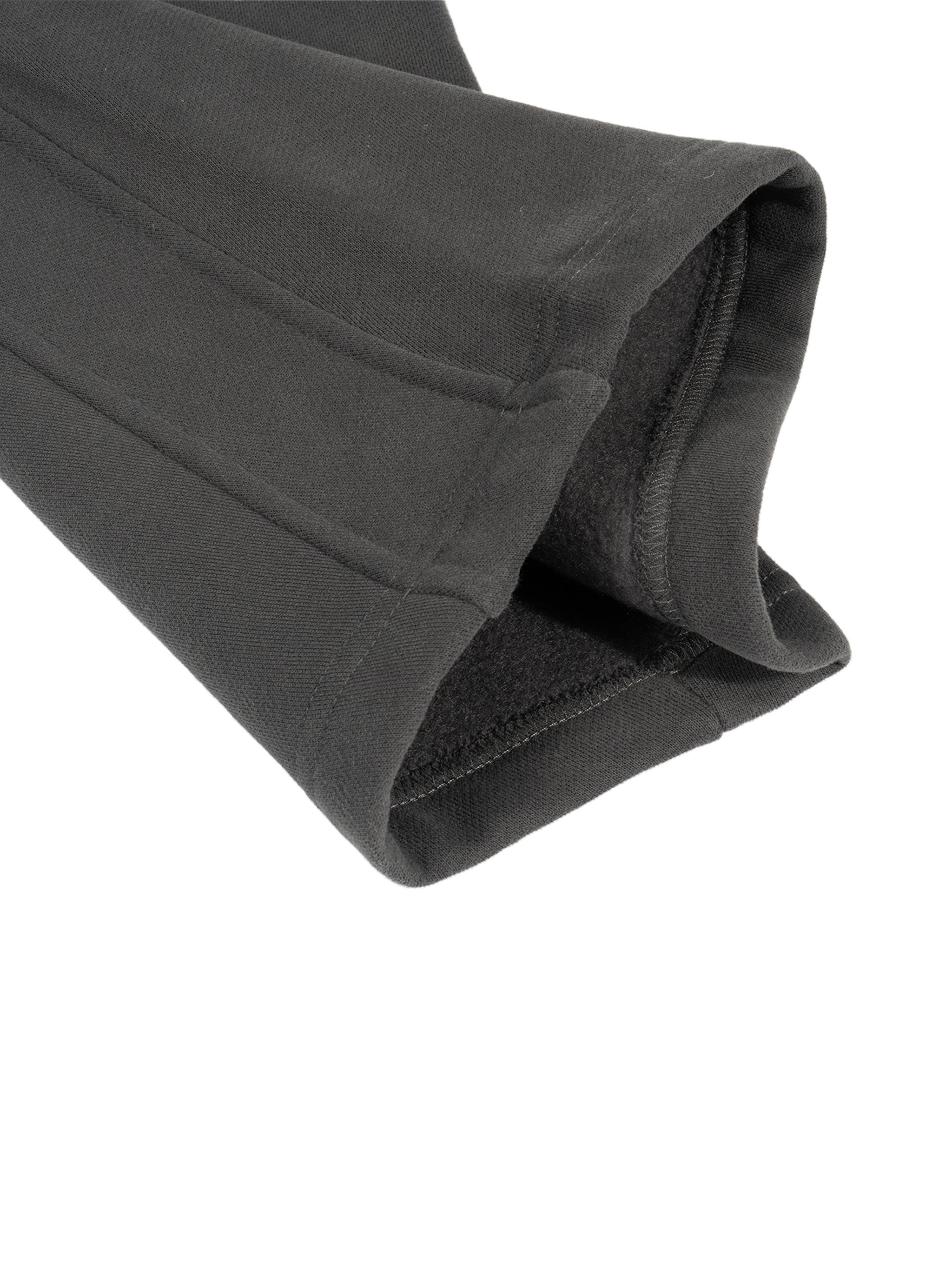 Close-up of heavyweight black fleece sweatpant cuff with detailed stitching
