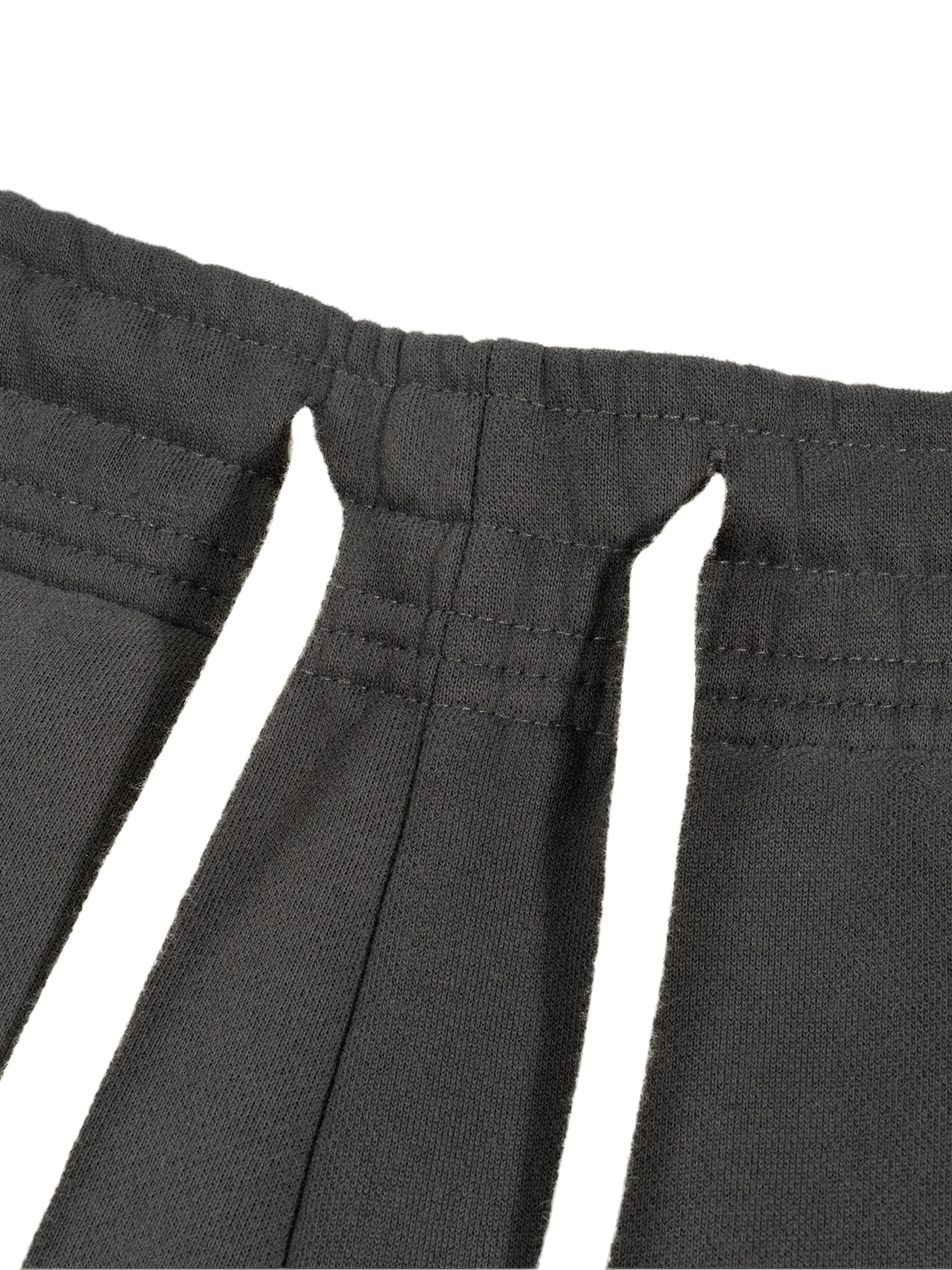 Close-up of heavyweight black fabric with unique slit details and reinforced stitching.