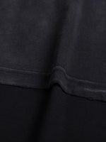 Tshirt fabric close-up in dark navy with visible seam and hem stitching