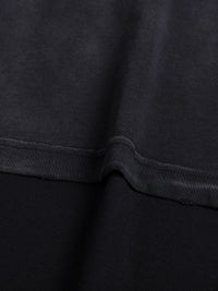 Tshirt fabric close-up in dark navy with visible seam and hem stitching