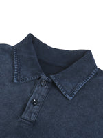 Close-up of a navy blue heavyweight washed polo shirt with button placket