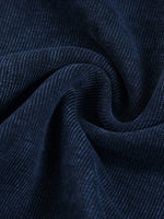 Close-up of dark blue heavyweight corduroy fabric with soft, textured ridges