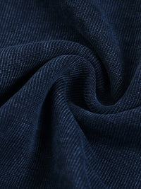 Close-up of dark blue heavyweight corduroy fabric with soft, textured ridges