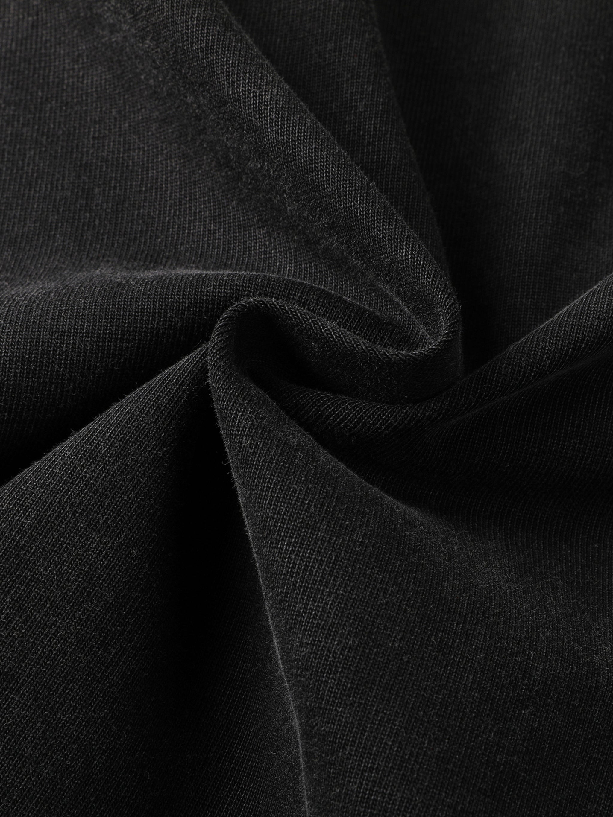 Close-up of heavyweight black streetwear fabric with soft texture and knit detail