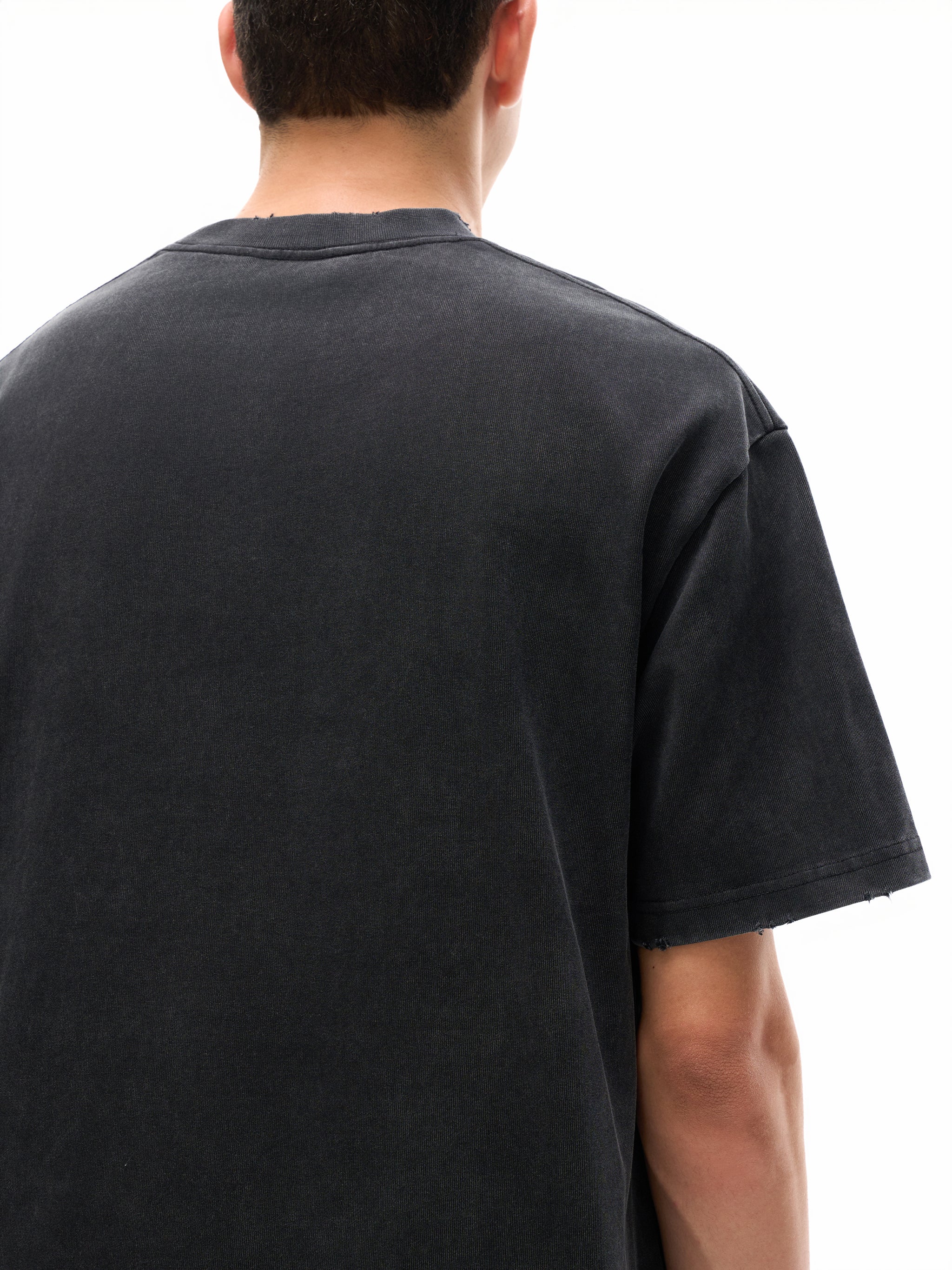 Back view of a heavyweight black short sleeve streetwear t-shirt on a male model