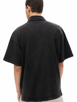 Back view of man wearing oversized black short sleeve heavyweight shirt