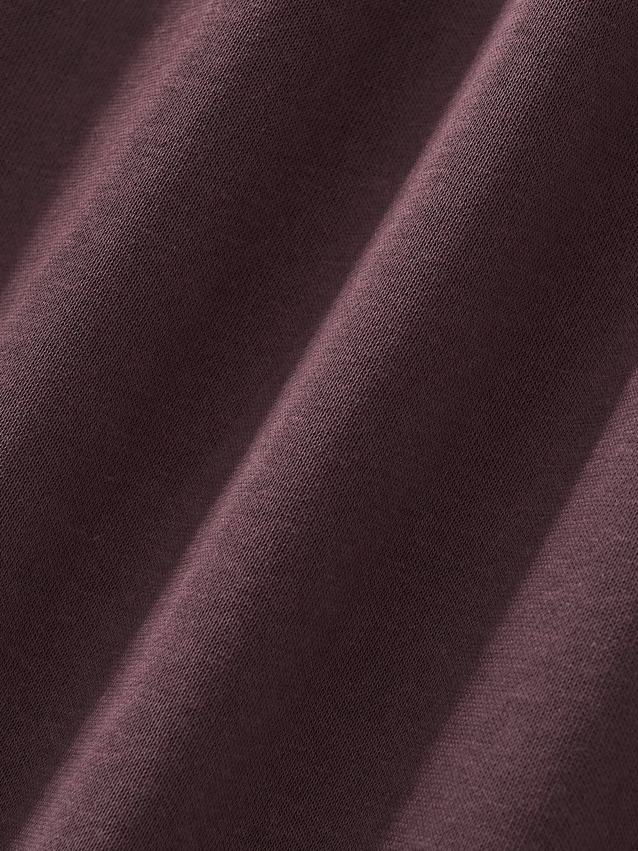 Close-up of heavyweight dark brown streetwear fabric with soft textured weave