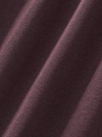 Close-up of heavyweight dark brown streetwear fabric with soft textured weave