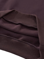Close-up of heavyweight streetwear sweatshirt hem in dark brown cotton with ribbed cuffs