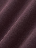 Close-up of heavyweight, textured brown streetwear fabric with soft, premium finish