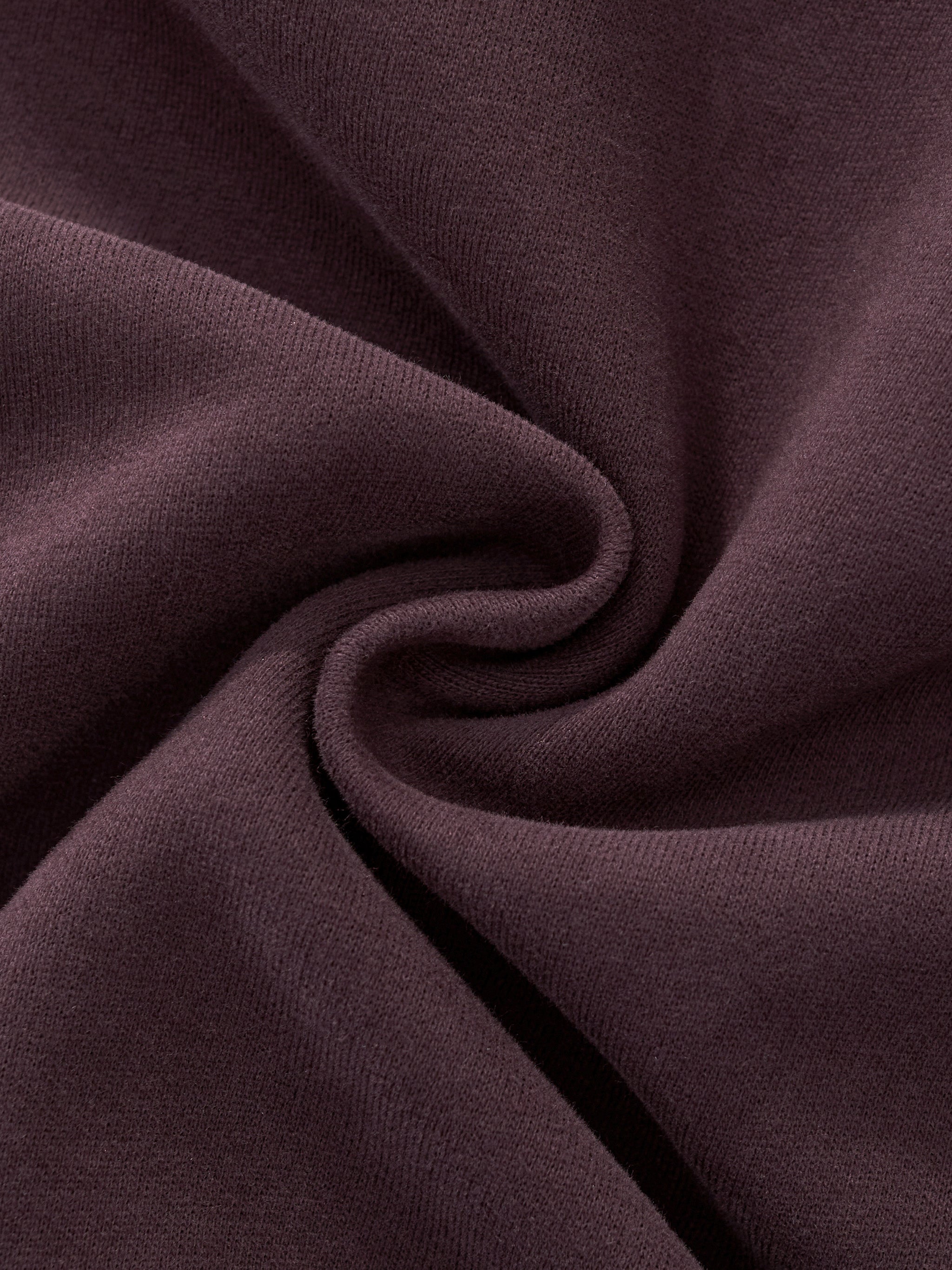 Close-up of heavyweight brown streetwear fabric with soft texture and subtle swirl pattern