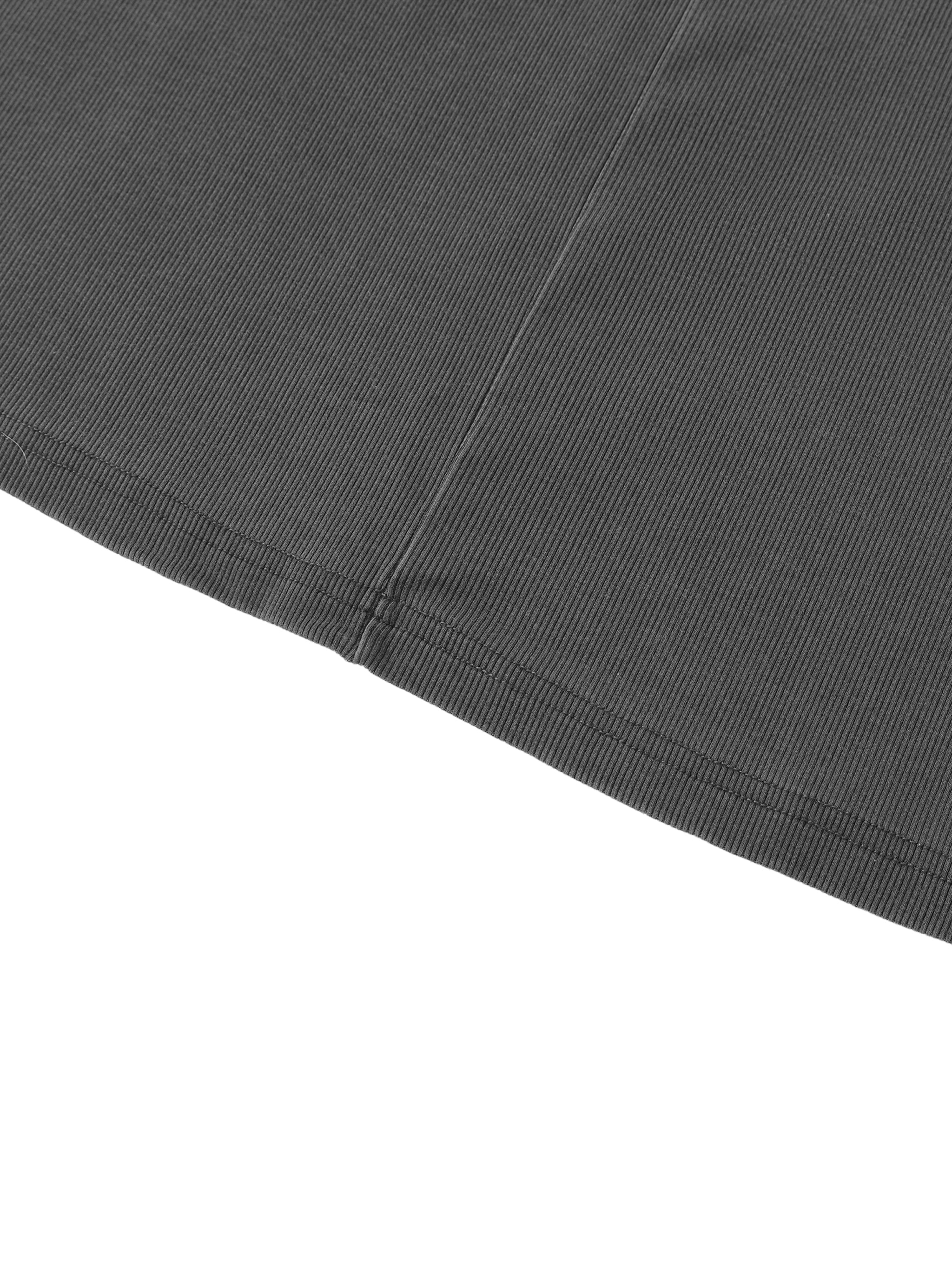 Close-up of heavyweight ribbed black streetwear fabric with detailed stitching