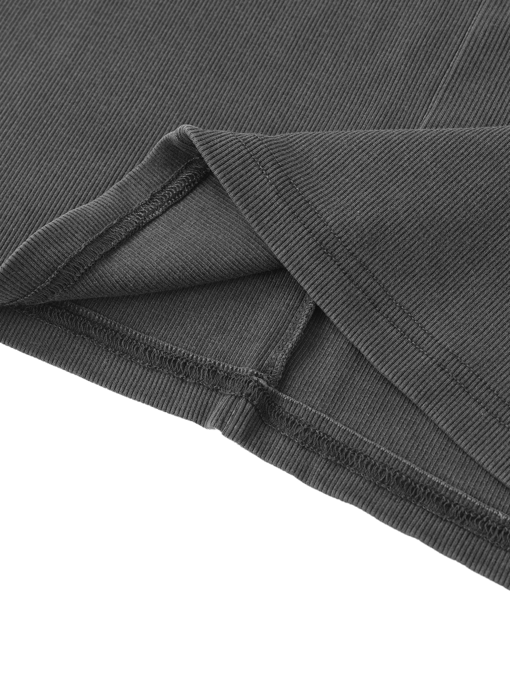 Close-up of black ribbed heavyweight streetwear fabric with stitched hem detail