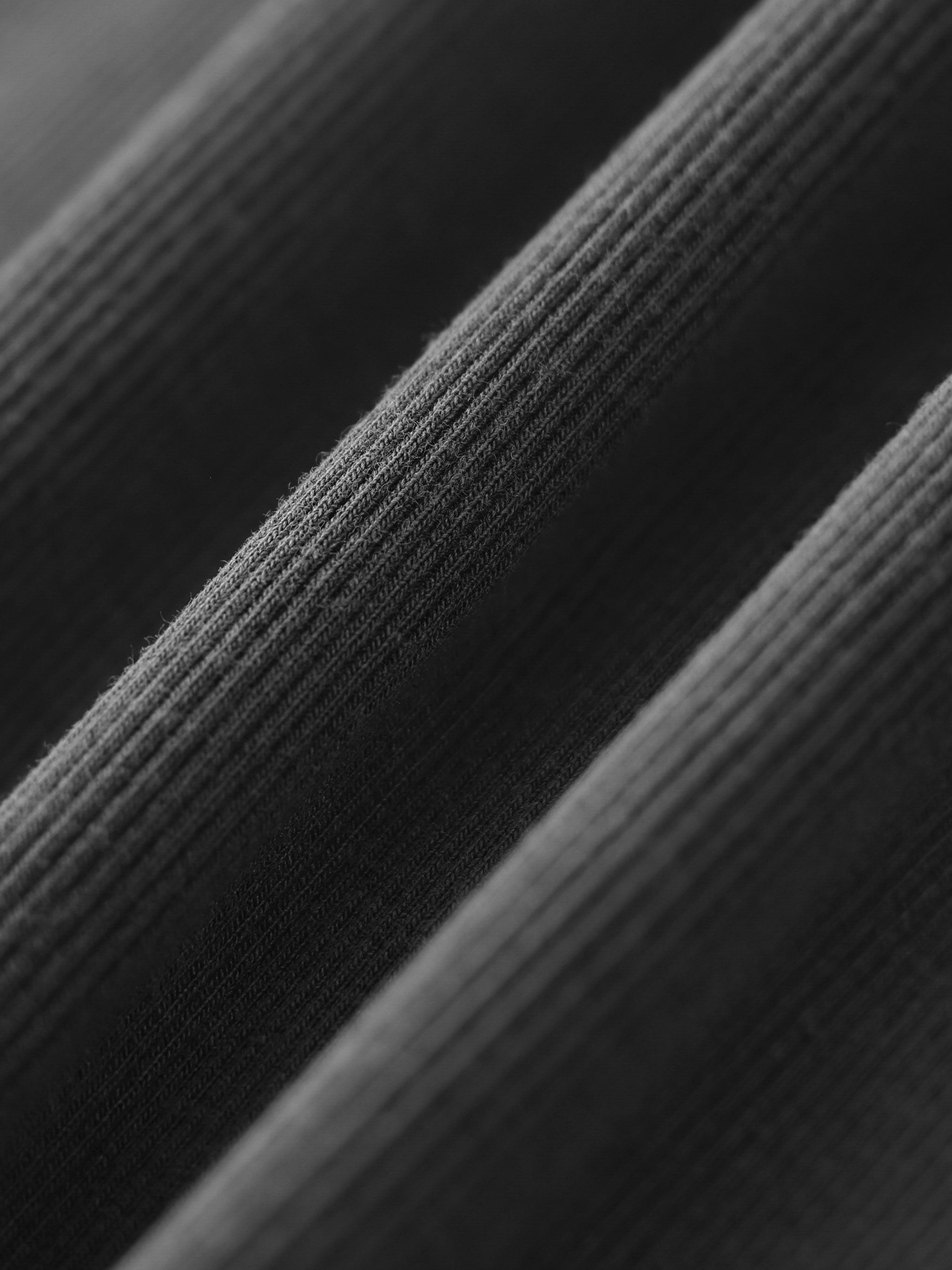 Close-up of heavy ribbed black fabric texture, premium streetwear material