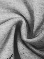 Zippered hoodie fabric close-up in gray fleece knit.
