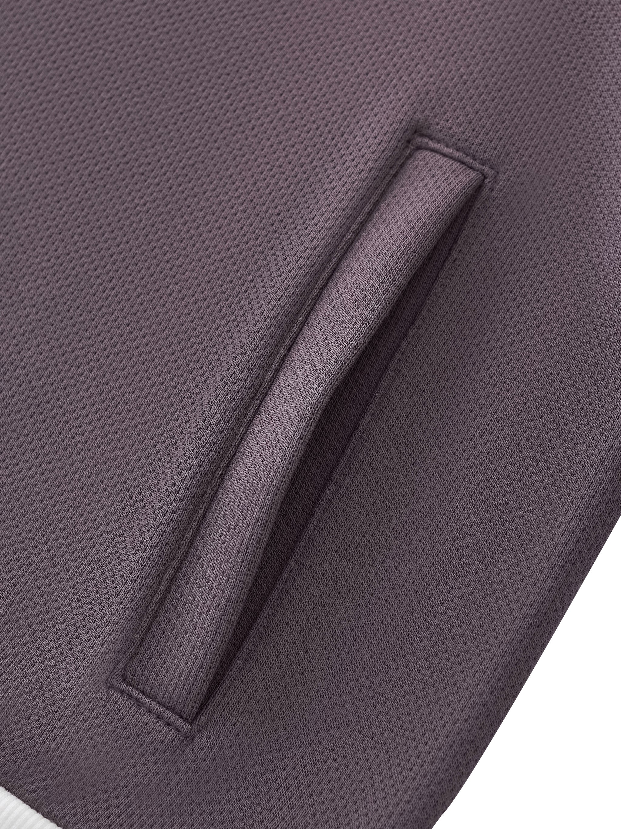 Close-up of textured heavyweight streetwear fabric with a sleek side pocket detail