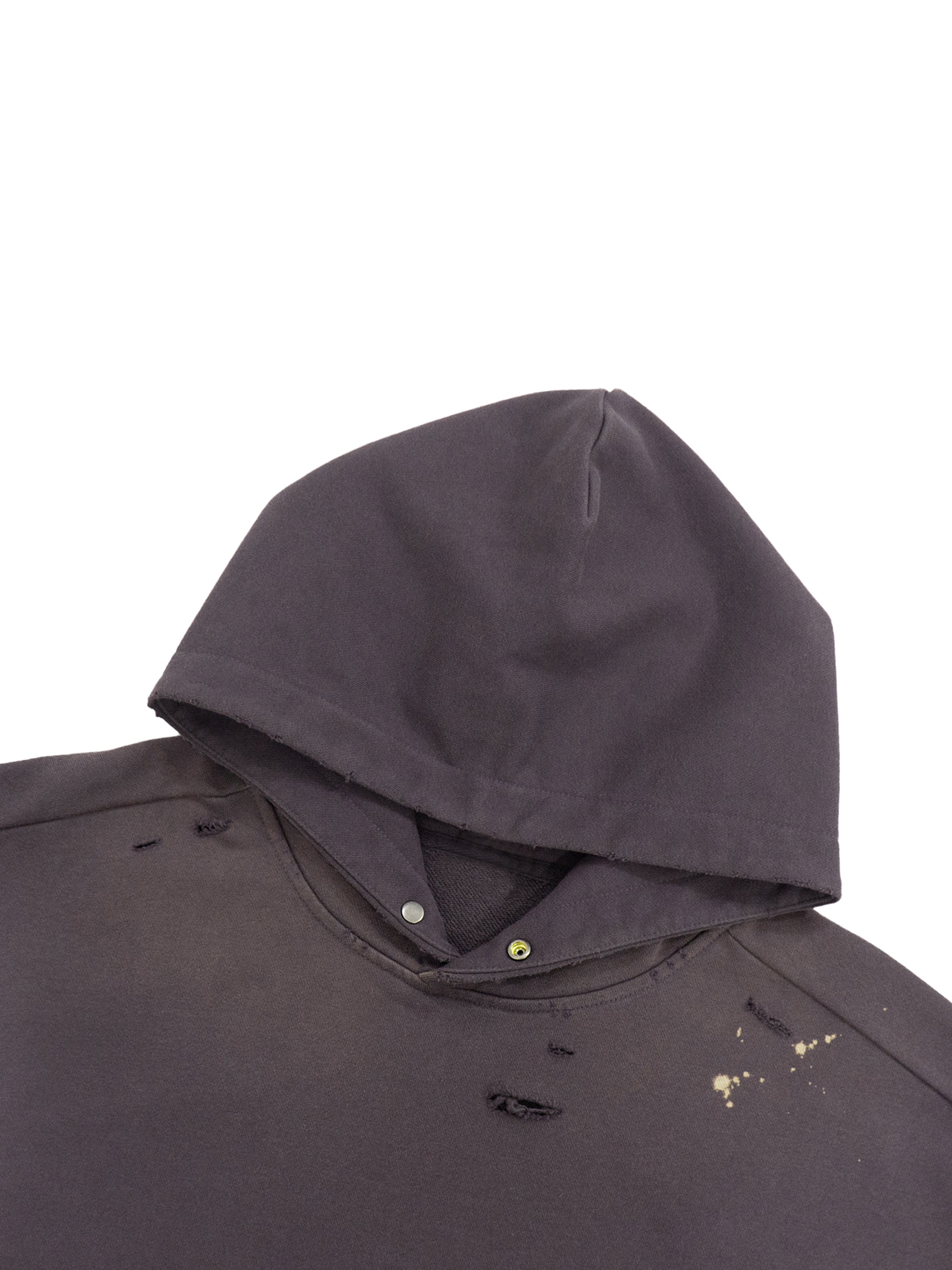 Distressed black hooded sweatshirt with paint splatter and raw edge details