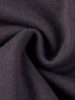 Close-up of heavyweight dark knit streetwear fabric with soft texture folds