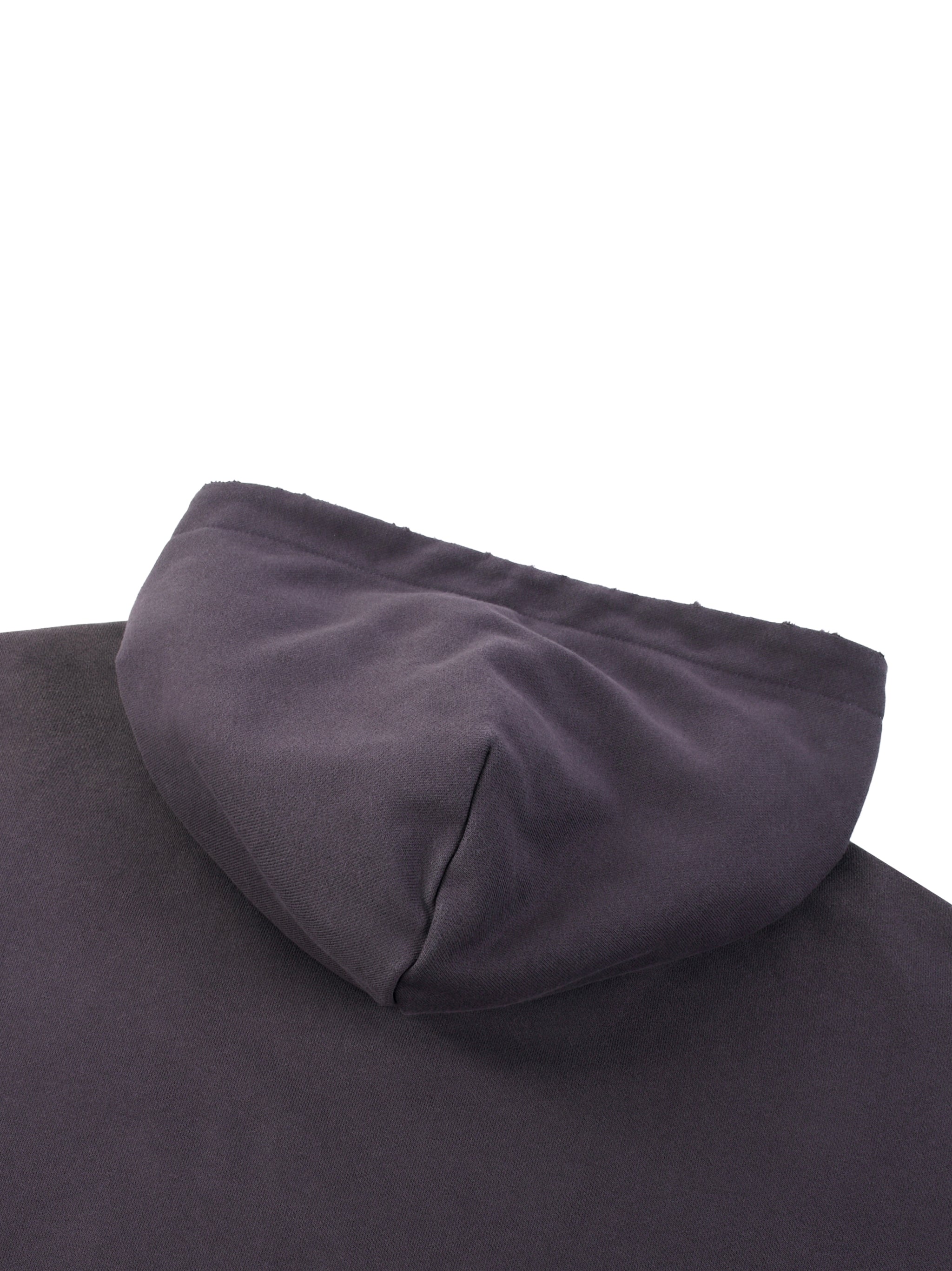 Close-up of a black heavyweight streetwear hoodie hood on a flat surface