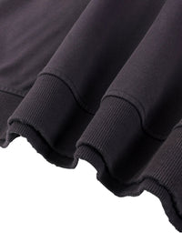 Close-up of heavyweight black streetwear sweatshirt with ribbed cuffs and raw hem