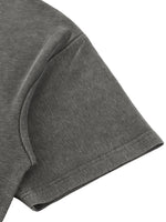 T-shirt sleeve in gray mineral-wash waffle-knit fabric; close-up shows textured, dotted weave.