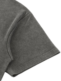 T-shirt sleeve in gray mineral-wash waffle-knit fabric; close-up shows textured, dotted weave.