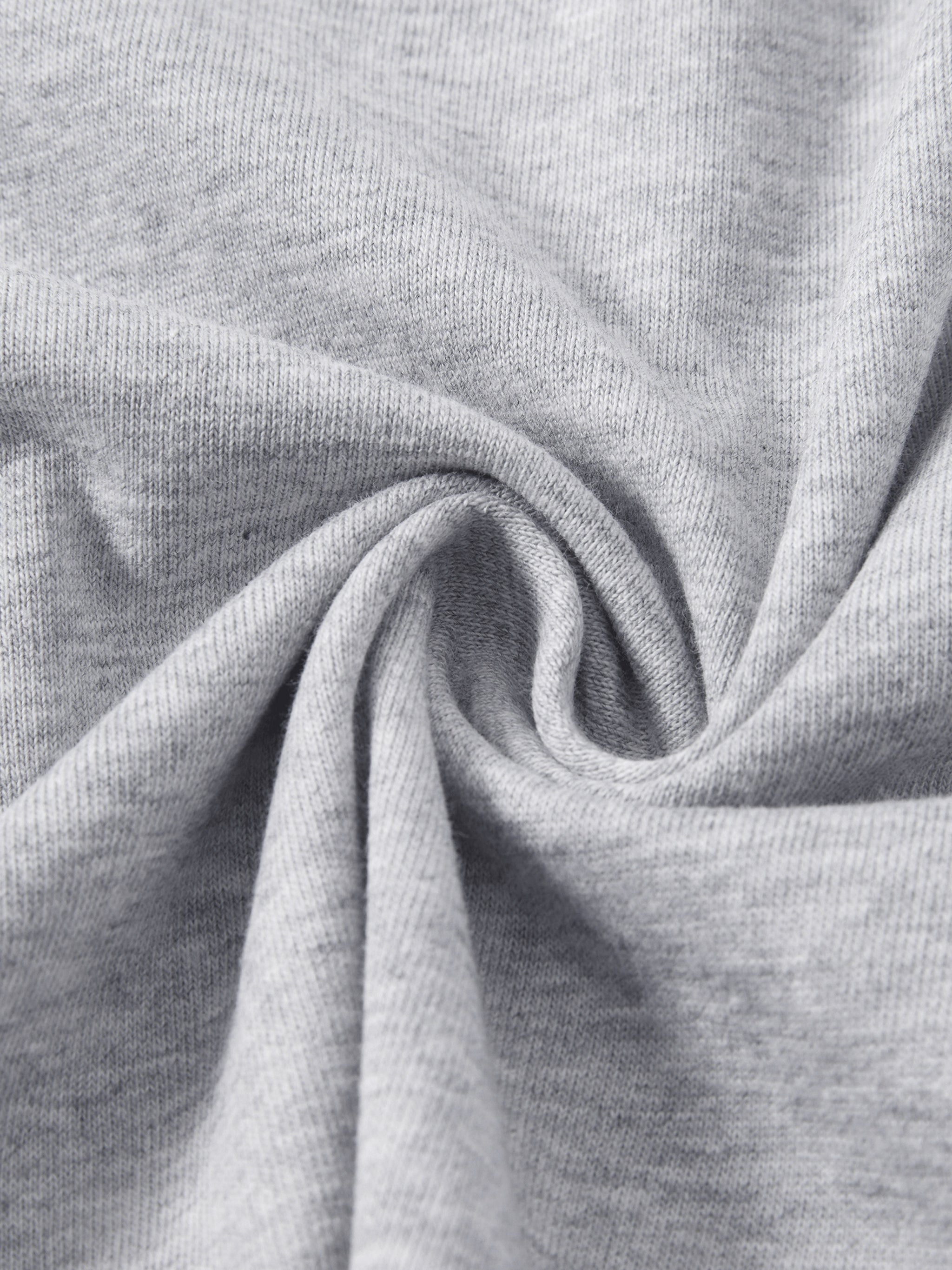Close-up of soft, heavyweight heather grey knit fabric swirled for texture detail