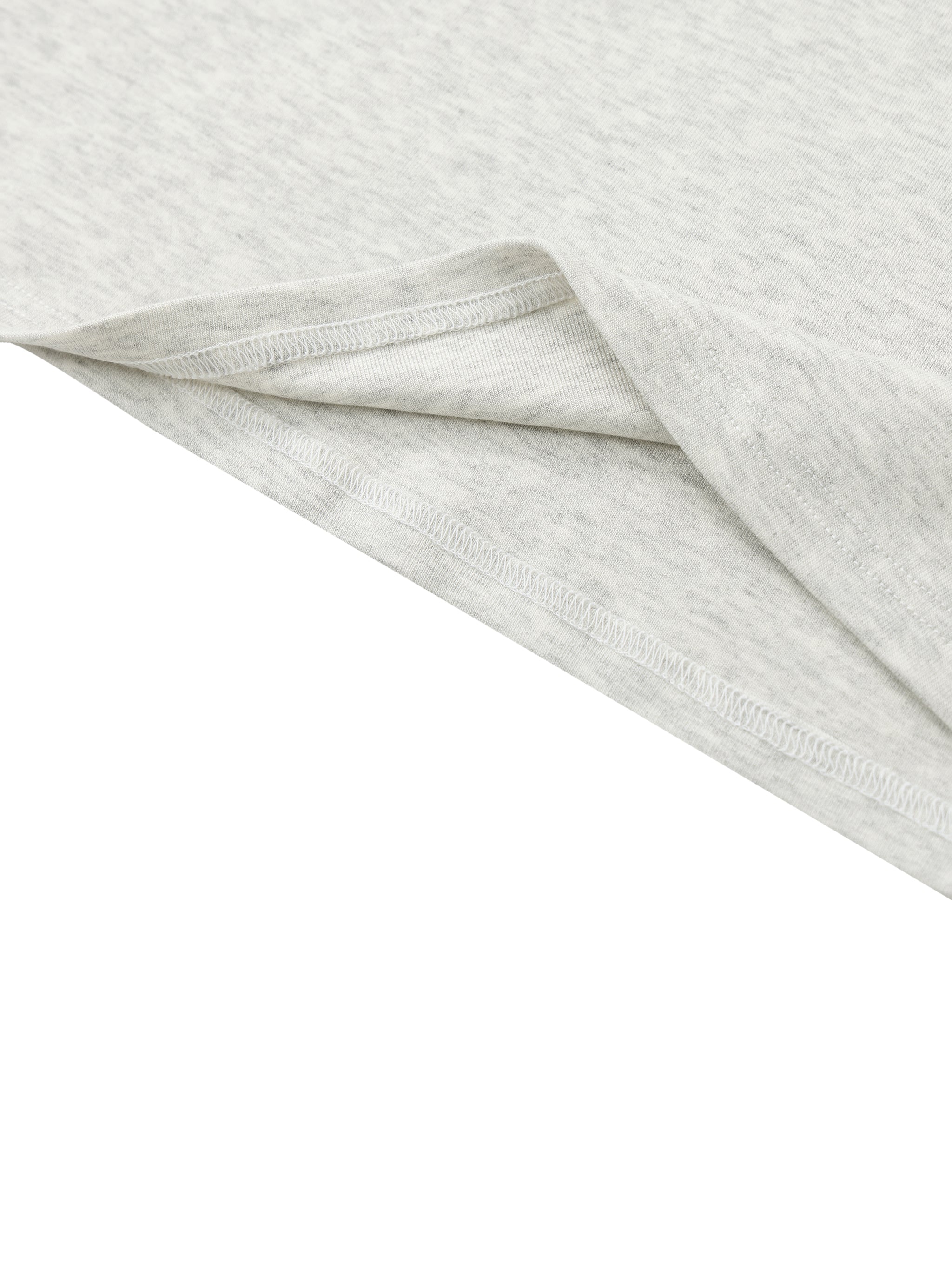 Close-up of light grey heavyweight t-shirt hem with visible stitching and fabric texture