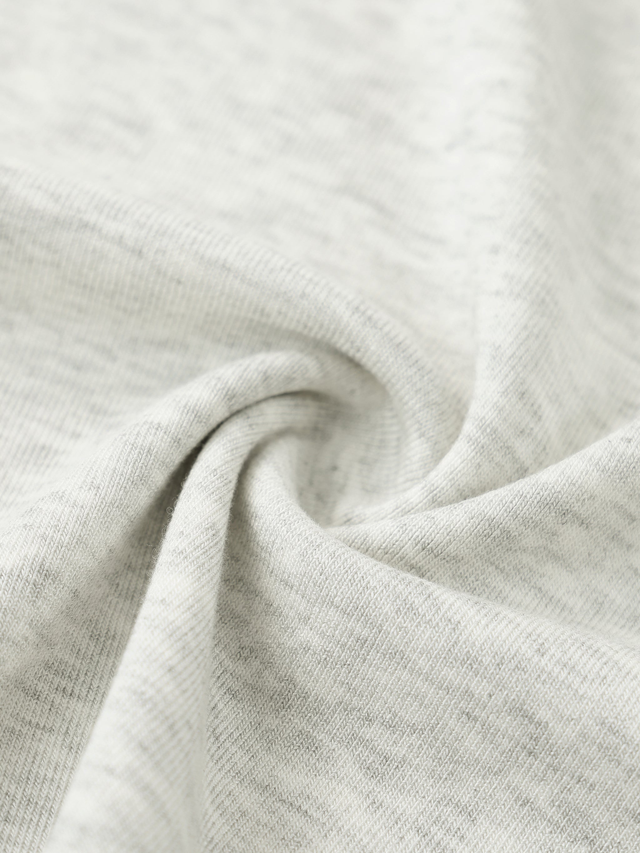 Close-up of soft, heavyweight heather grey cotton streetwear fabric texture