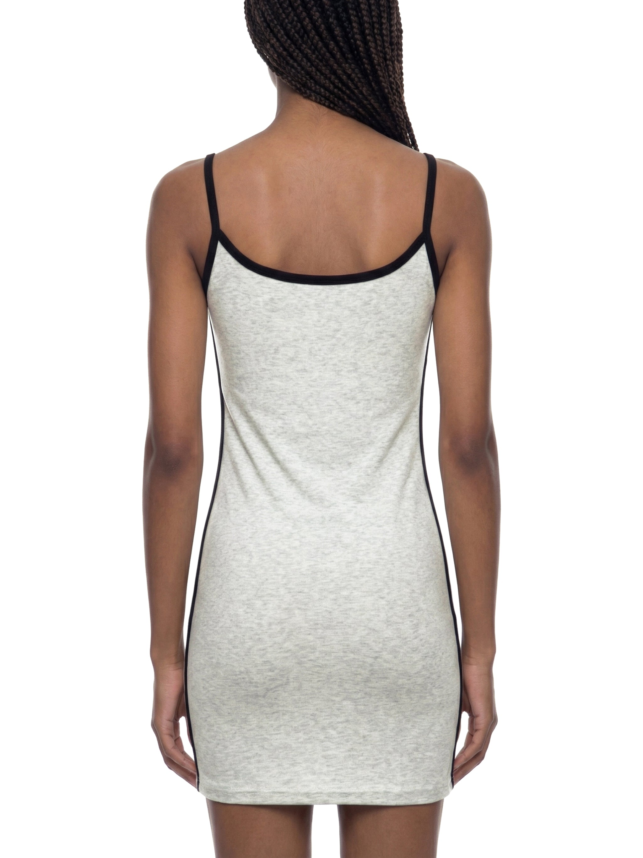 Back view of woman wearing light grey bodycon mini dress with black trim and spaghetti straps