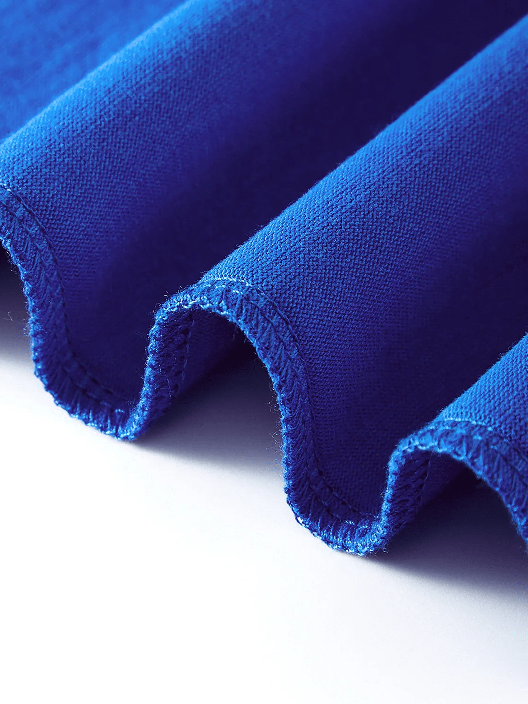 Close-up of bright blue pure cotton fabric with fine stitching detail