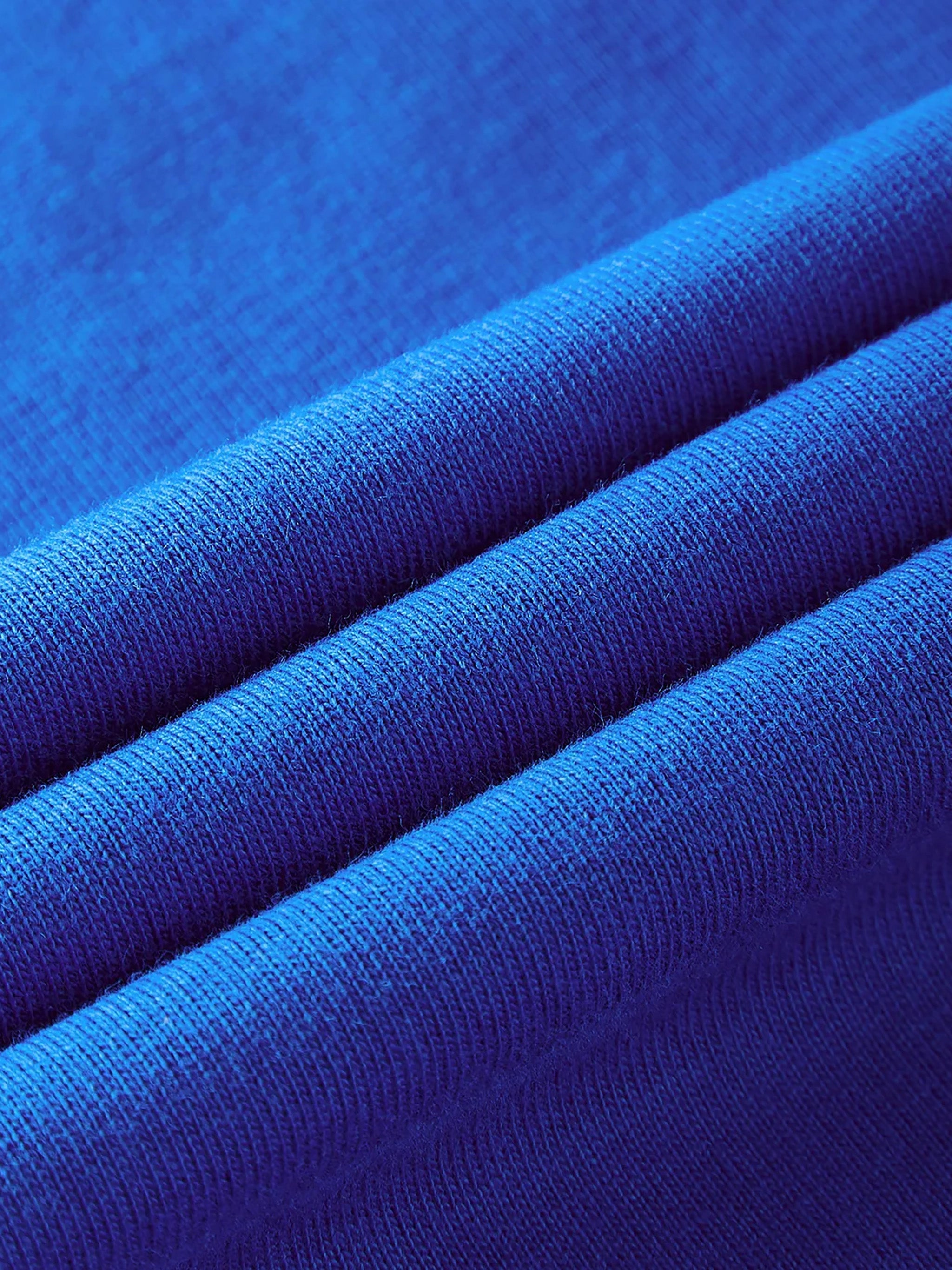 Close-up of vibrant blue pure cotton t-shirt fabric with visible texture and soft weave.