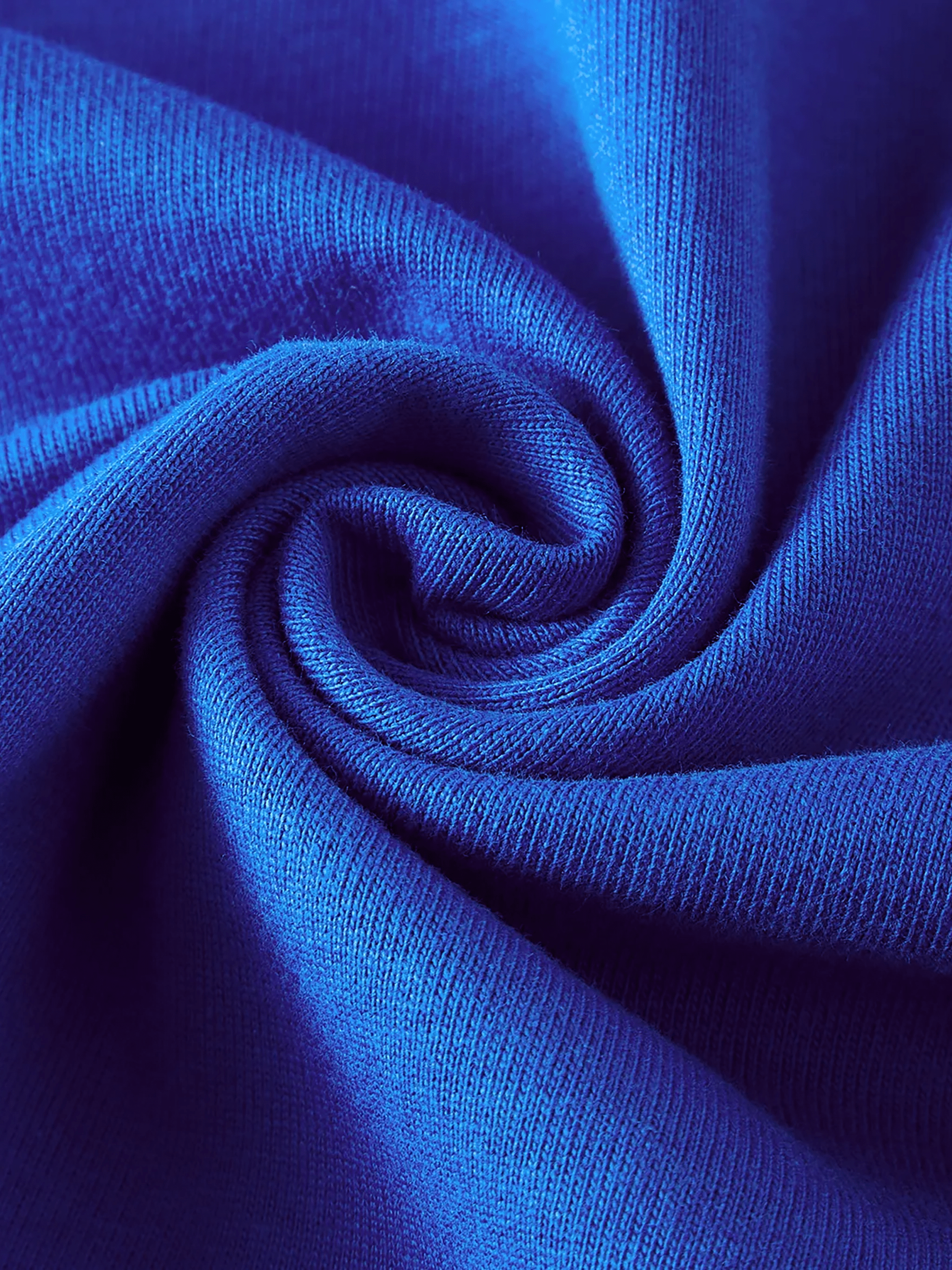 Close-up of vibrant blue cotton fabric with a soft, smooth texture and spiral fold.