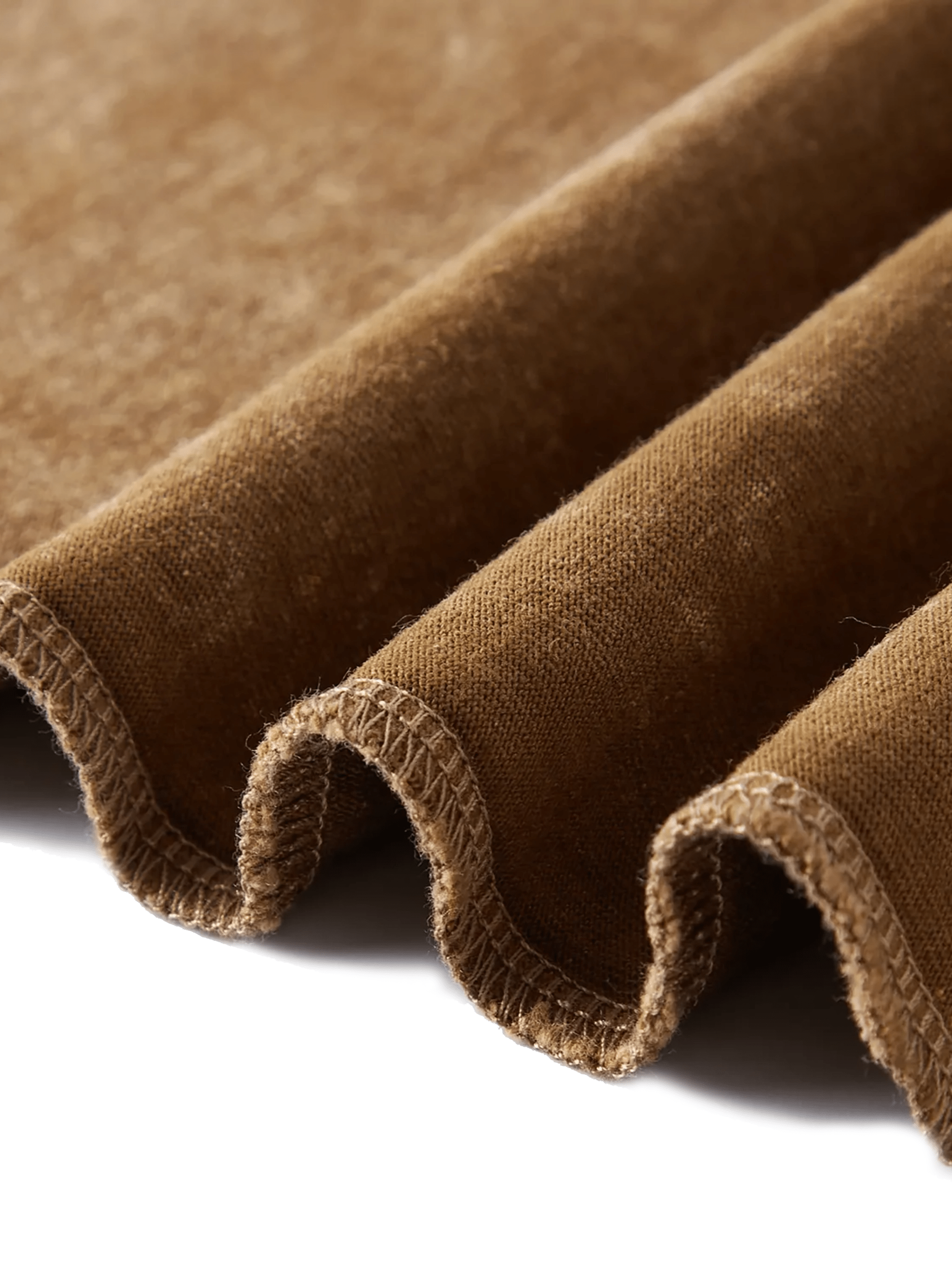 Close-up of brown heavyweight cotton fabric with visible texture and finished seam