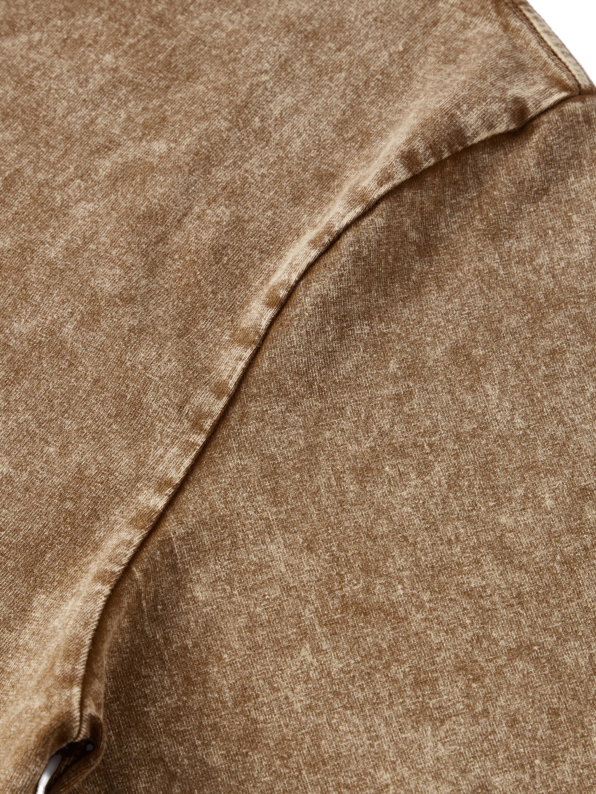 Close-up of snow washed kids t-shirt in brown with soft textured fabric and seam detail