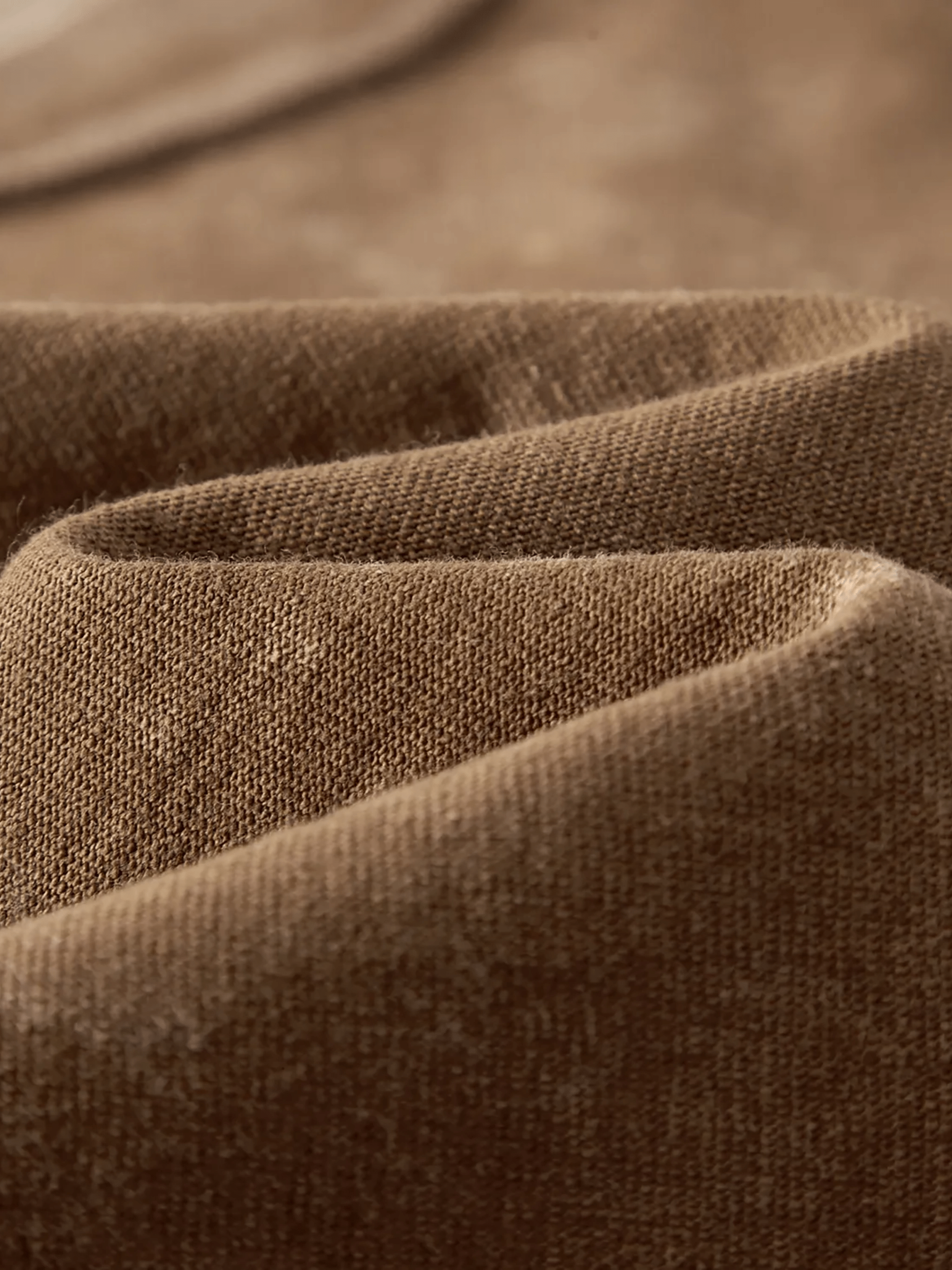 Close-up of heavyweight brown snow washed kids t-shirt cotton fabric texture