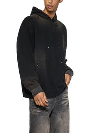 Black sun-faded frayed fleece hoodie with distressed details, worn by male model