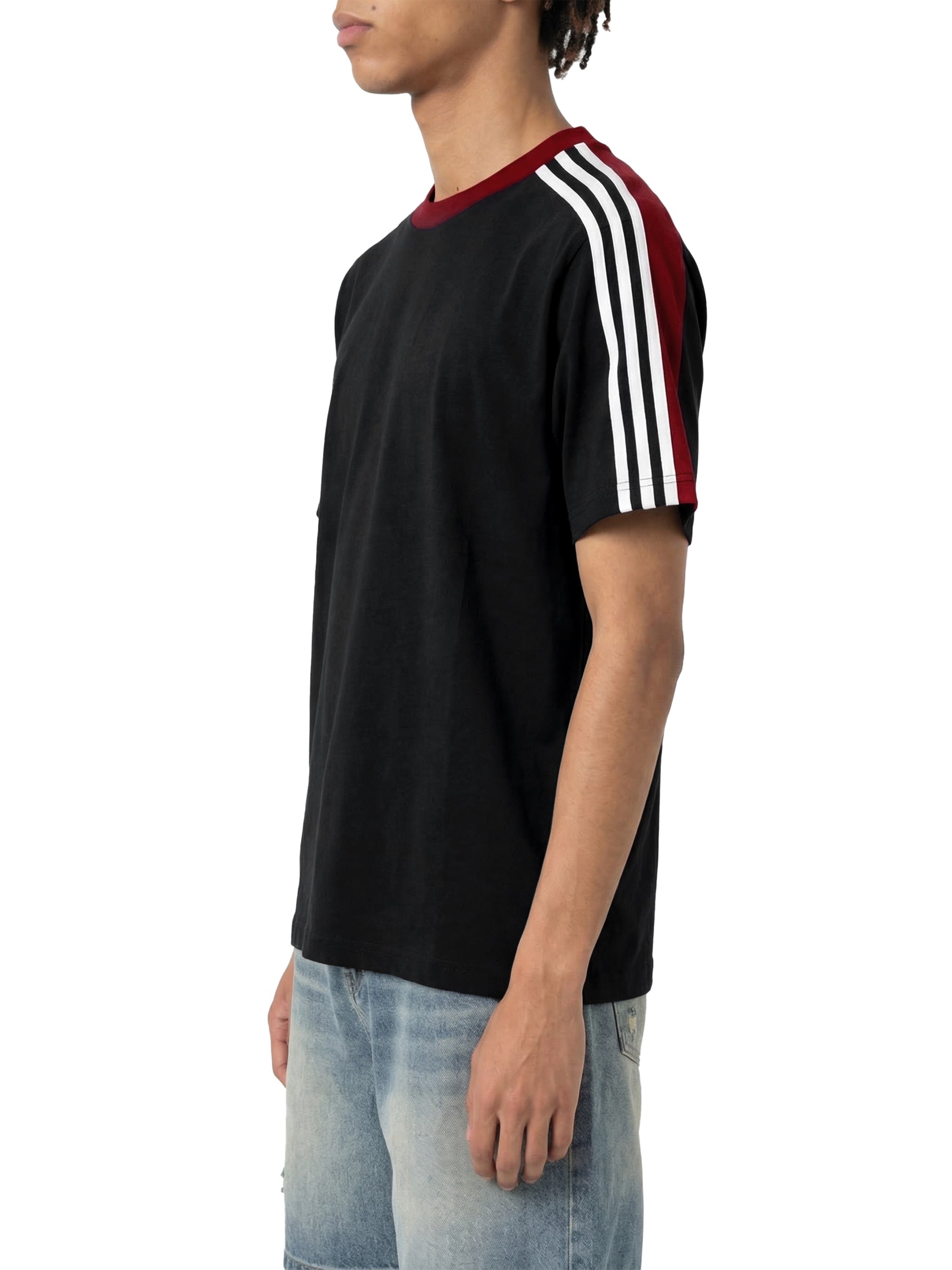 Unisex black colorblock t-shirt with red collar and white striped sleeves, worn with jeans