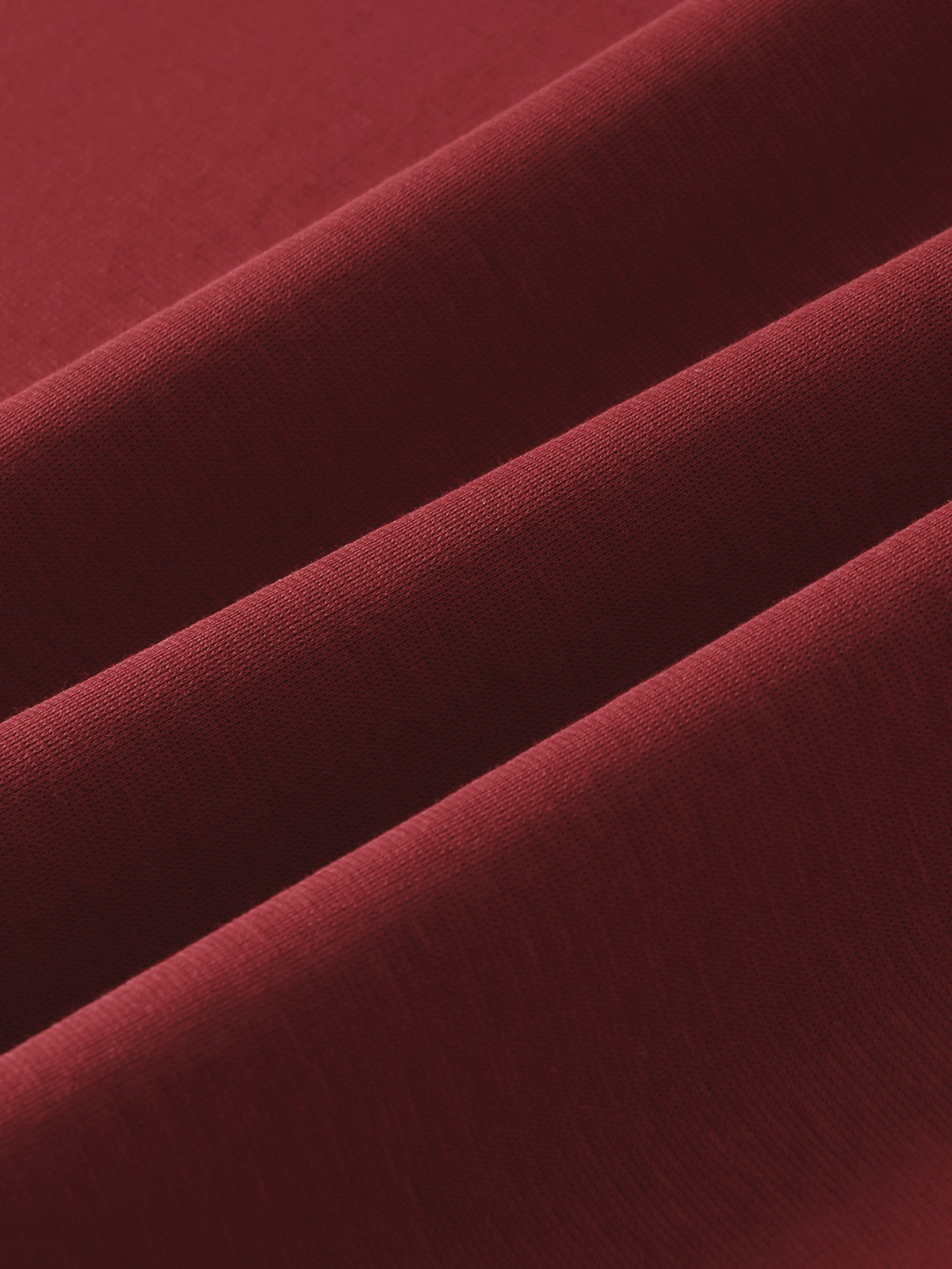 Close-up of heavyweight maroon cotton fabric with visible texture and soft folds