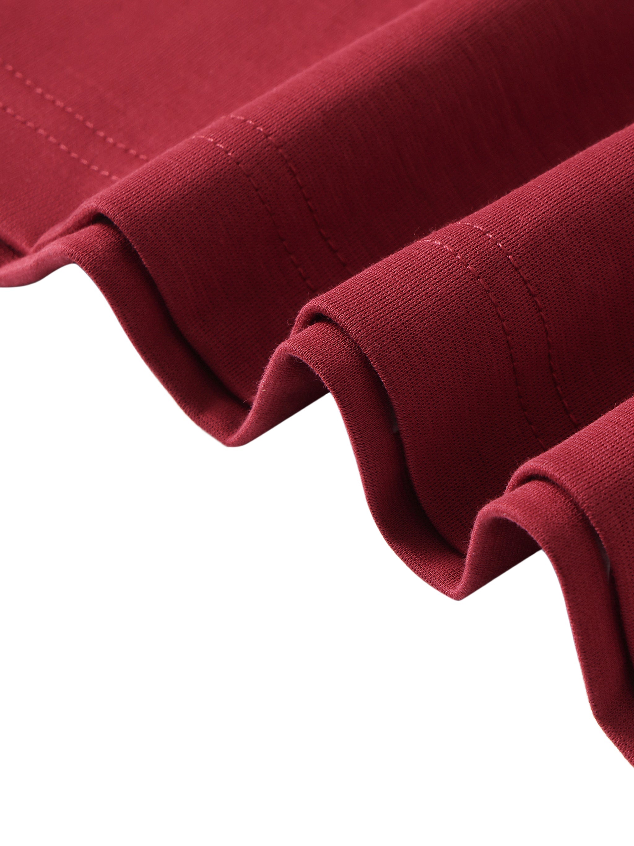 Close-up of maroon heavyweight streetwear fabric with detailed stitching.