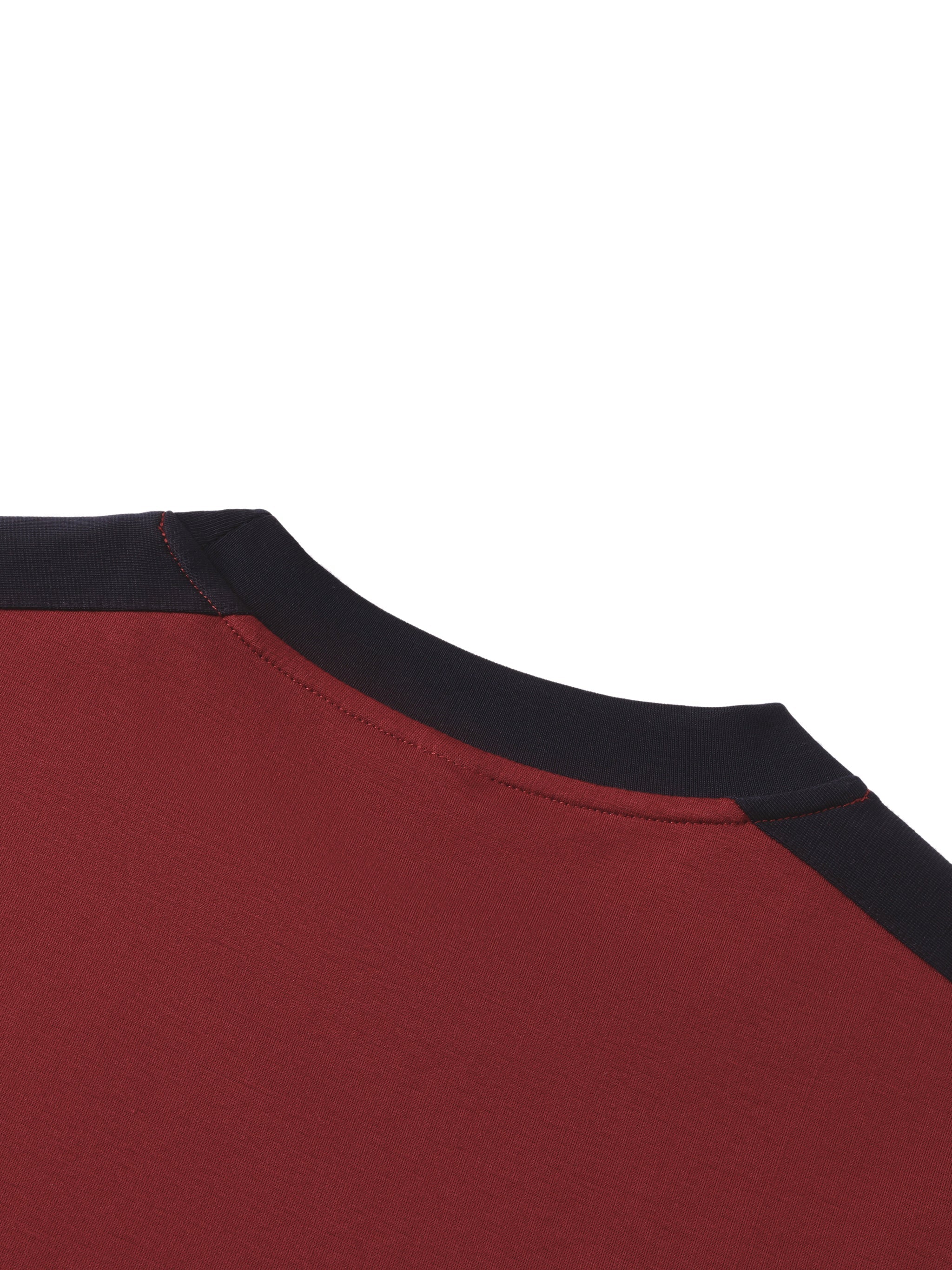 Close-up of a burgundy unisex t-shirt with contrasting black crew neckline detail