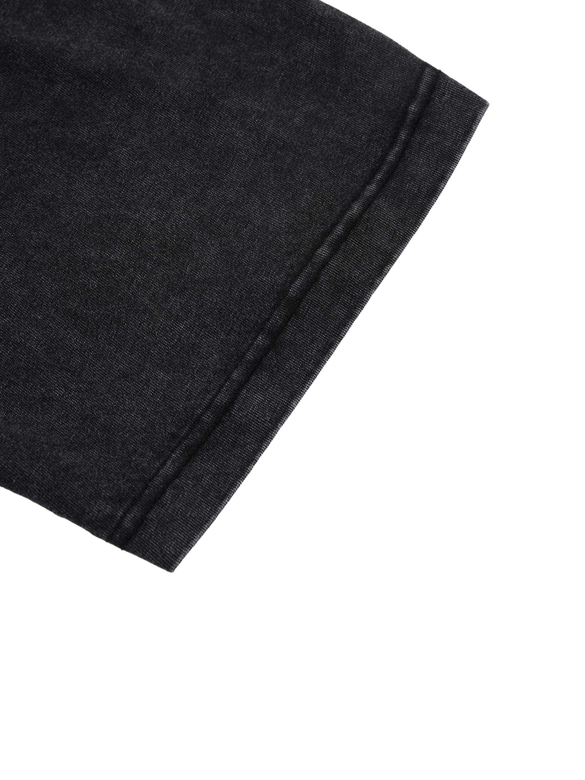 Closeup of black vintage wash heavyweight boxy t-shirt sleeve hem on white background
