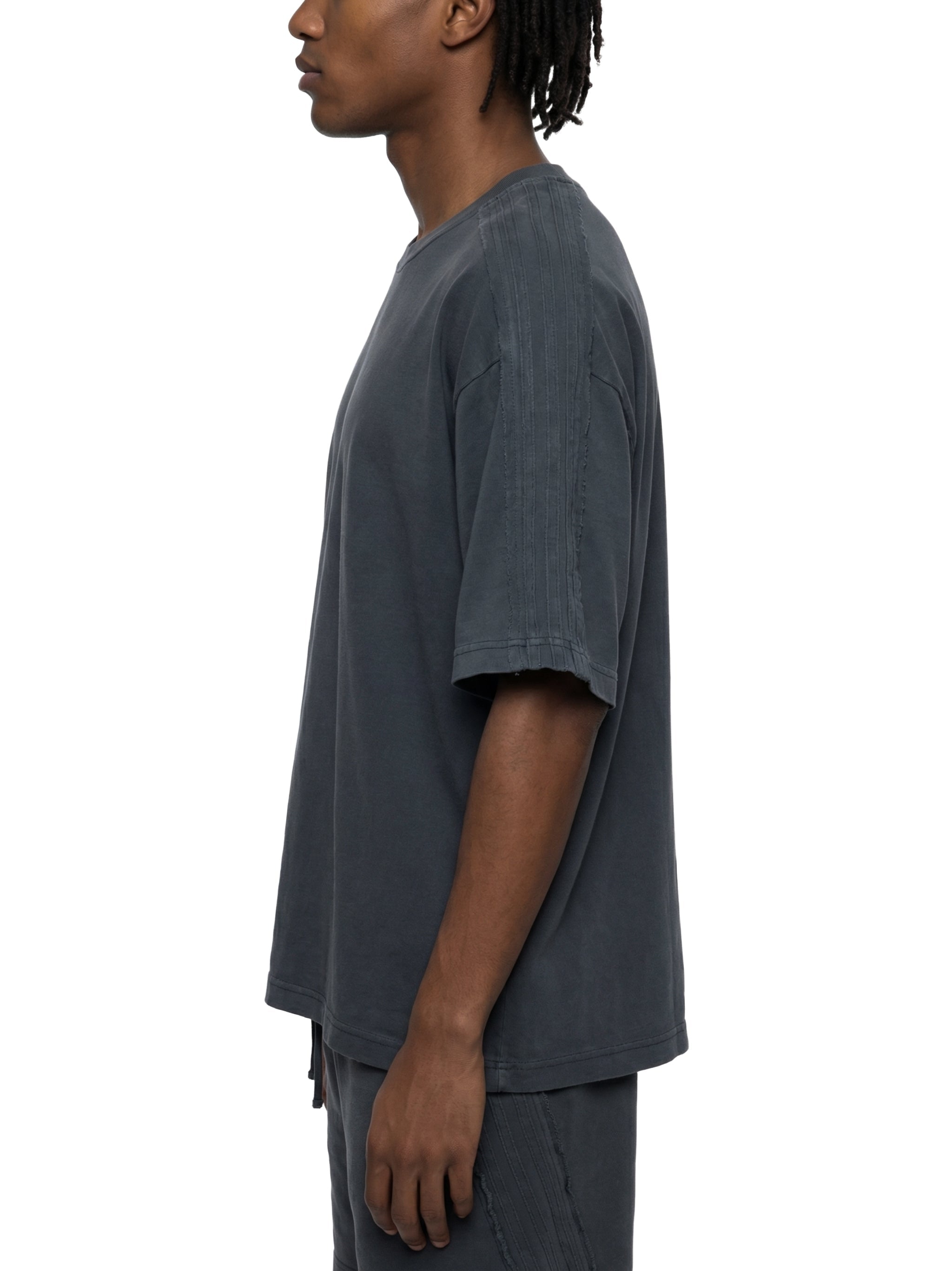Unisex vintage wash boxy t-shirt in dark grey, side profile view, heavyweight streetwear