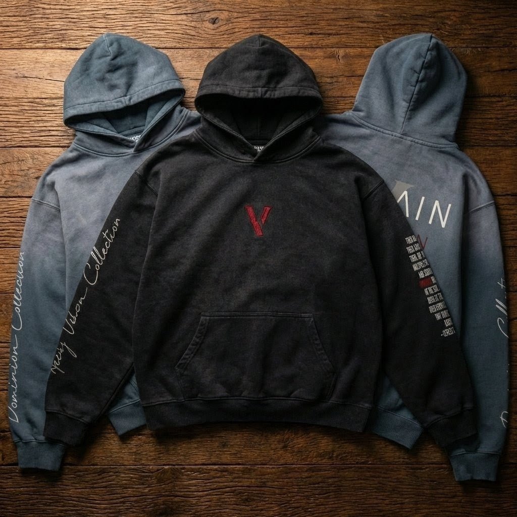 Three heavyweight sunfade oversized hoodies with graphic text and embroidery on wooden floor.