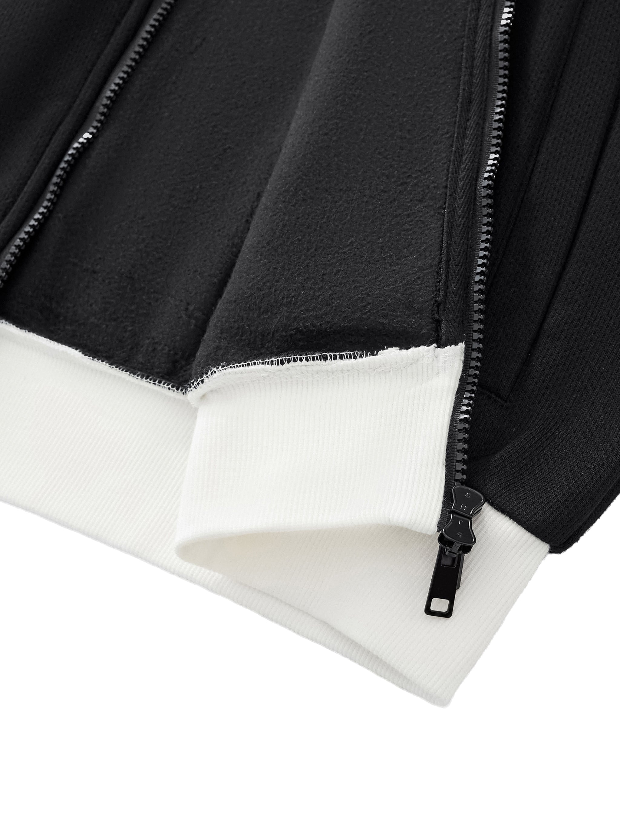 Close-up of black fleece track jacket with white ribbed cuffs and exposed zipper