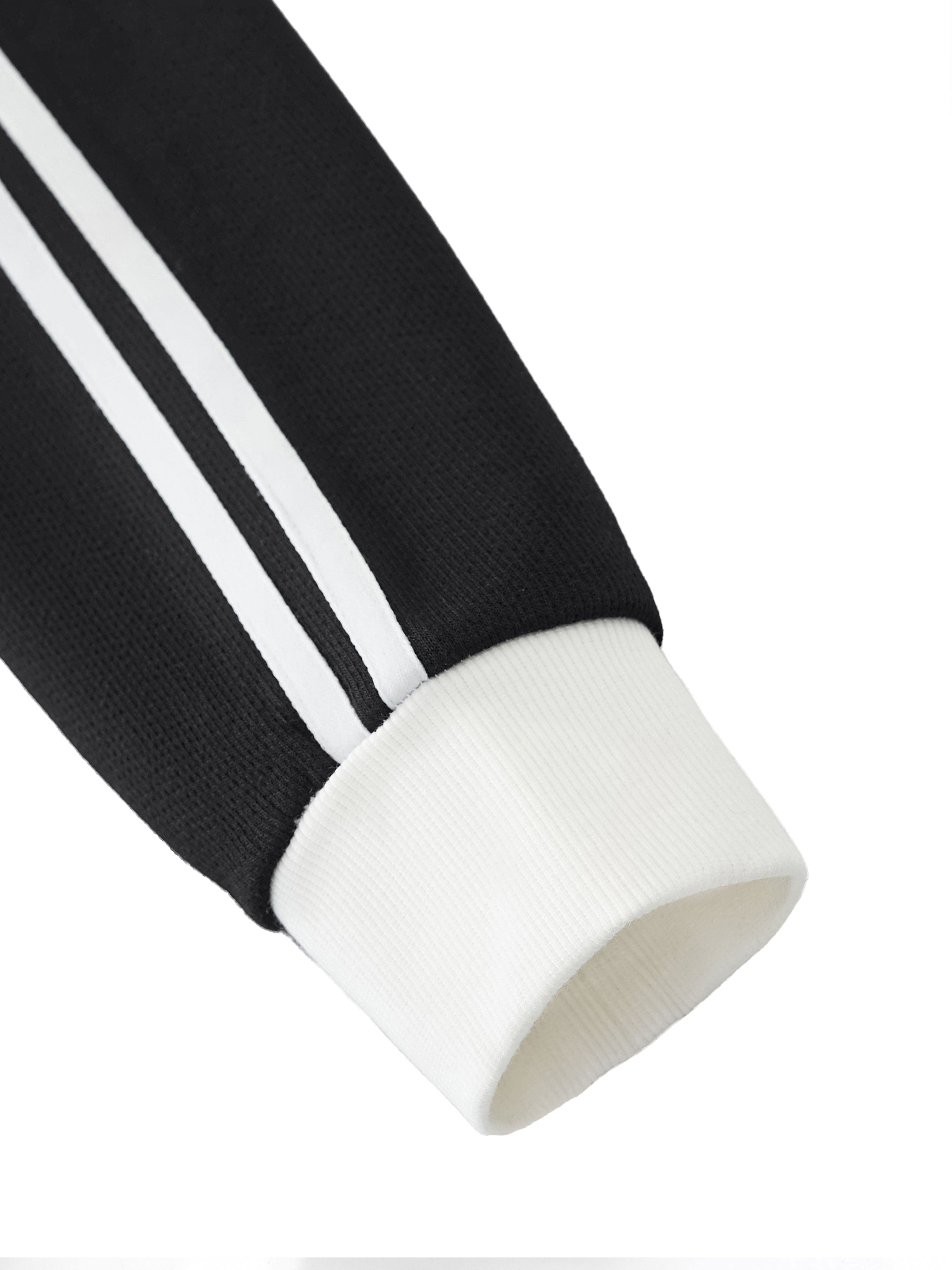 Black fleece track jacket sleeve with white side stripes and ribbed white cuff